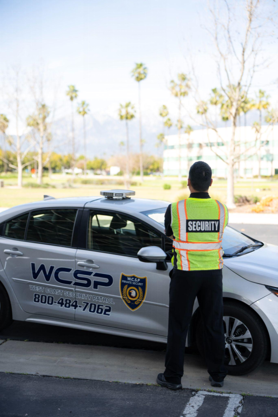 Security guard inspecting construction site perimeter fencing and gates