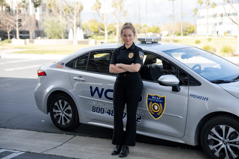 An image of a security guard standing against a car