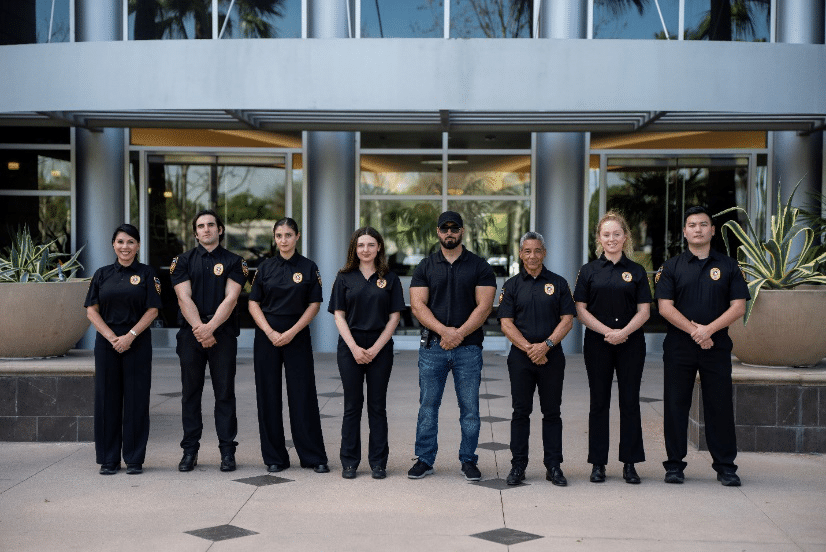 An image of security guards posing in front of a building