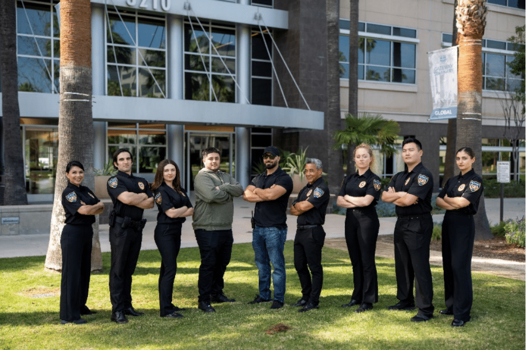 An image of security guards posing in front of a building