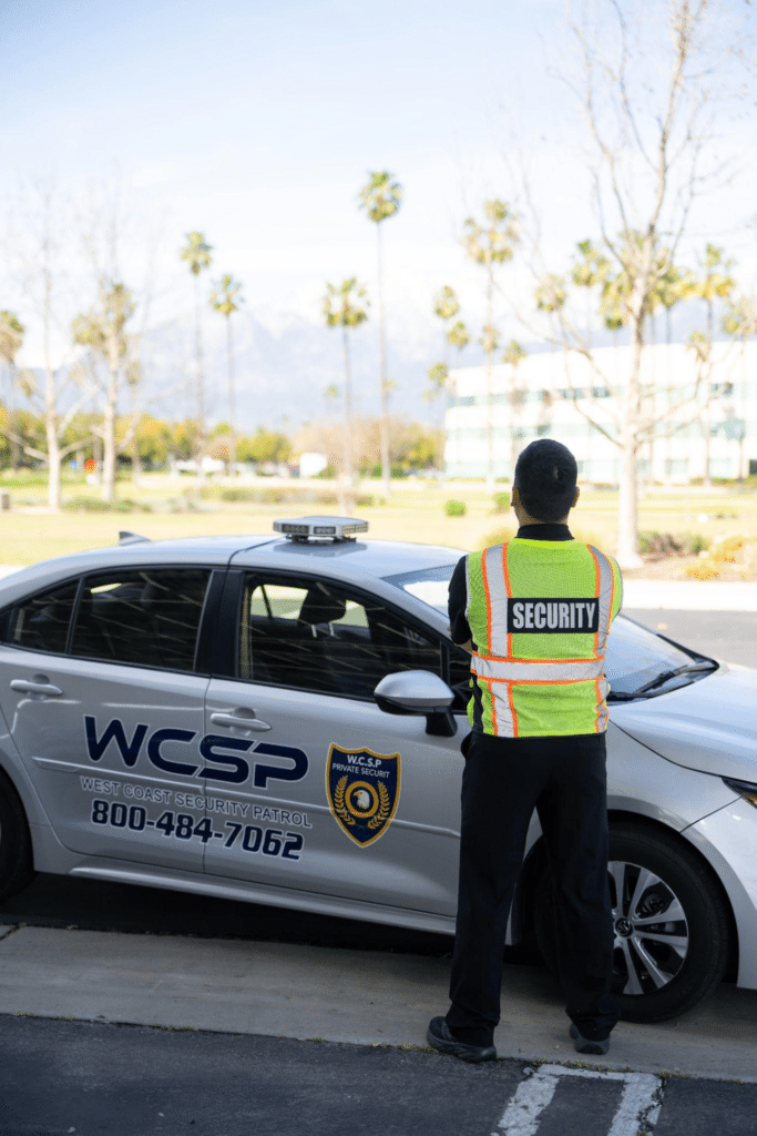 Security guard inspecting construction site perimeter fencing and gates