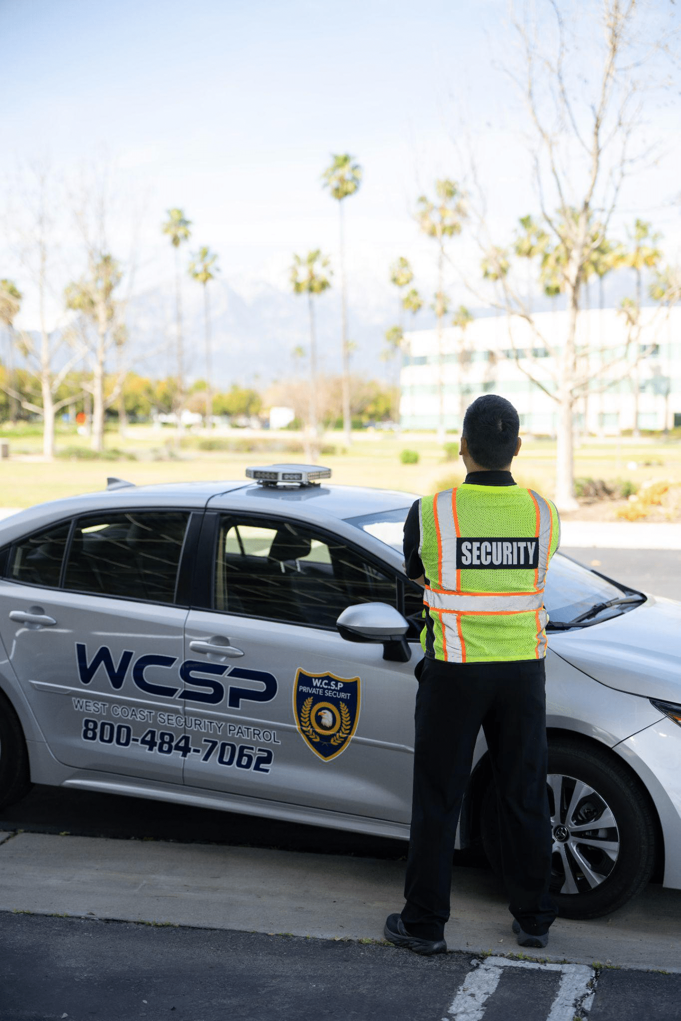 Security guard inspecting construction site perimeter fencing and gates