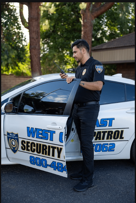Guard beside patrol car