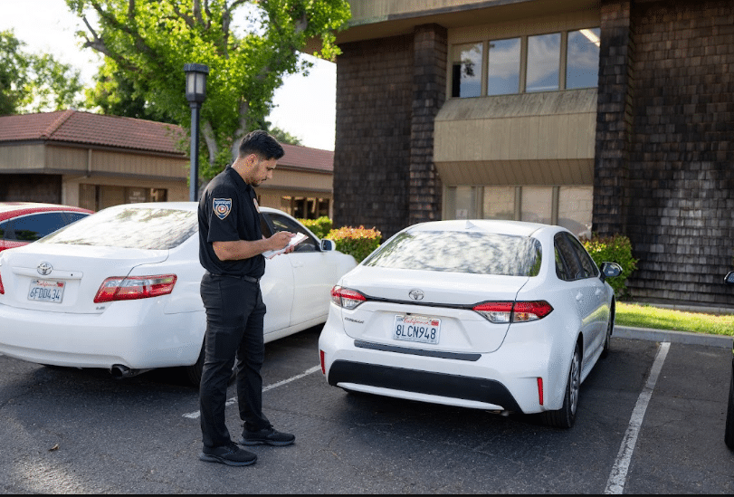 Guard checking a vehicle in a parking area