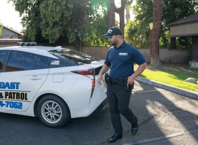 Guard standing near a building exterior wall